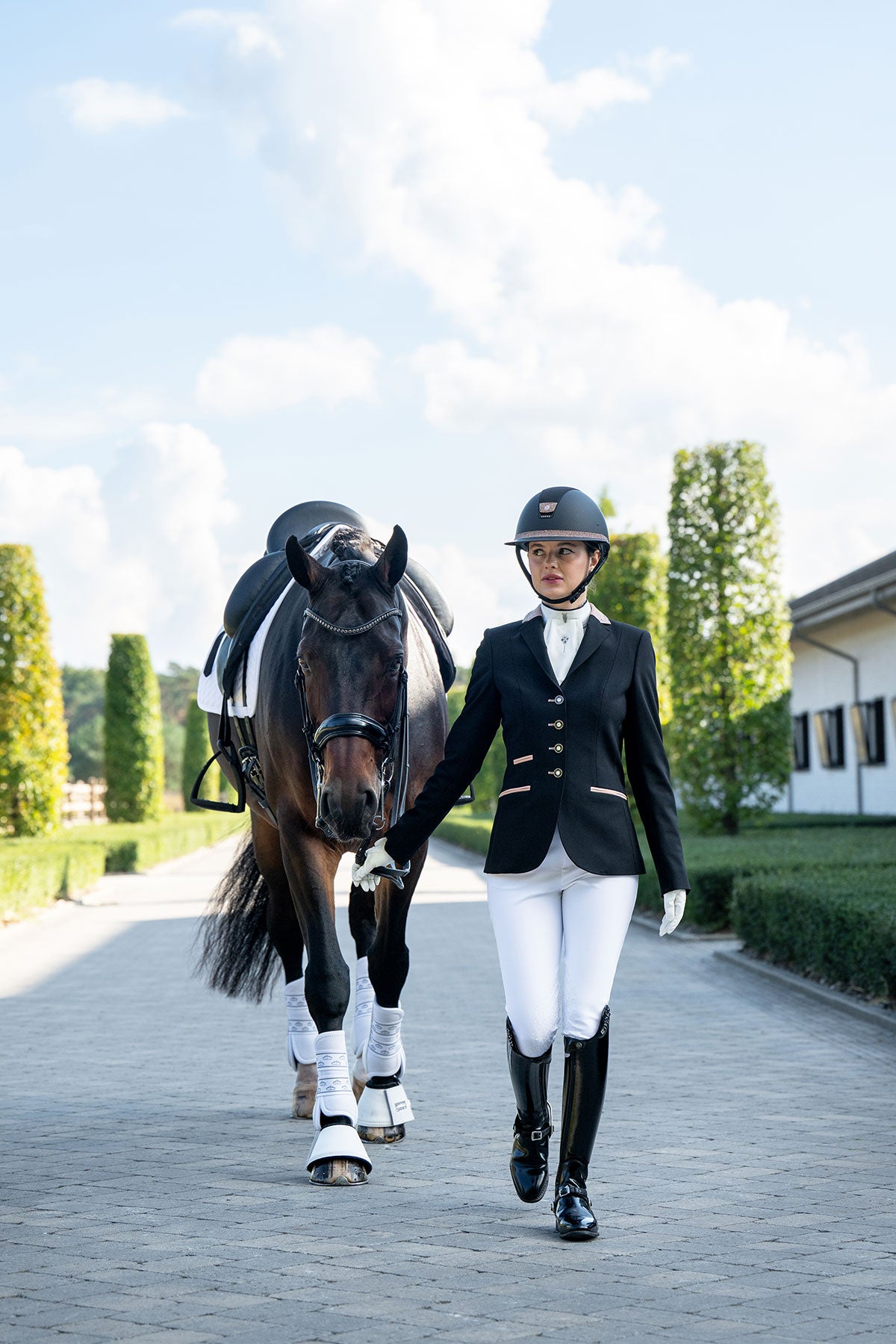 JuulC Black Shimmer Women's Competition Jacket with soft pink accents and Swarovski crystals, in motion