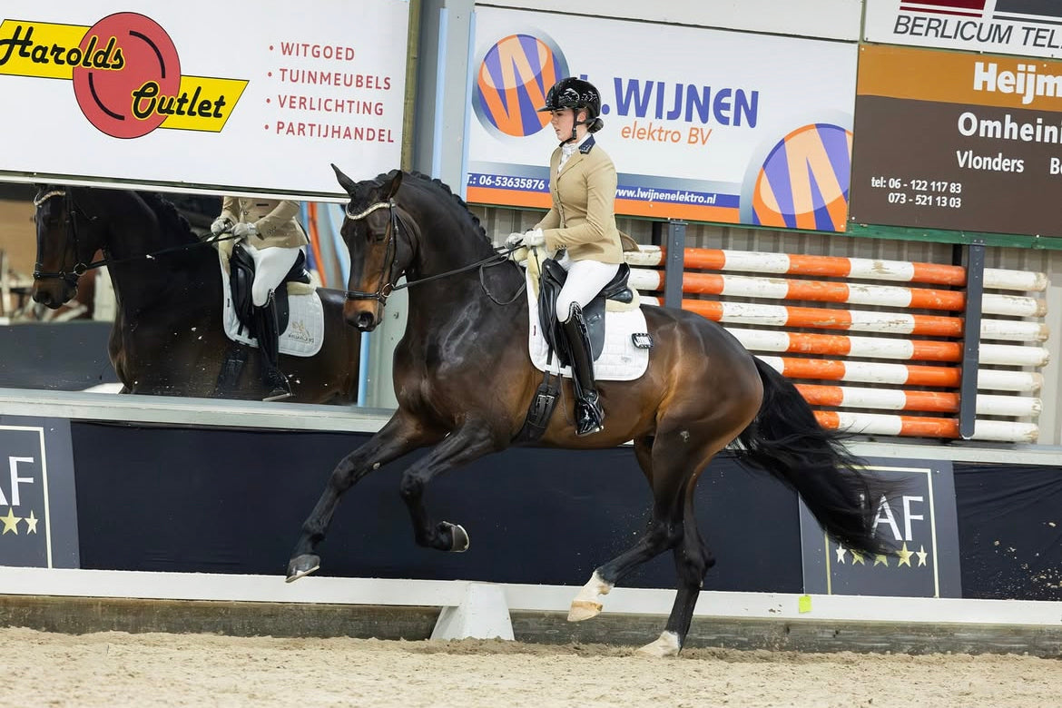 Romy Veldmeijer riding a dressage test for young horses, wearing her JuulC competition jacket