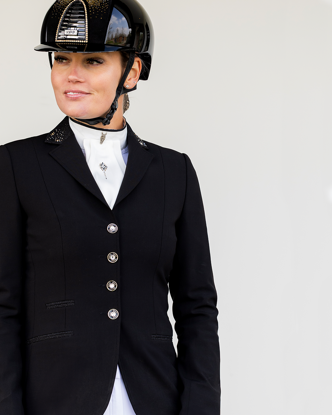 Detail of front of JuulC Women's show jacket in Black Stardust with glitter fabric accents on the collar, worn by model